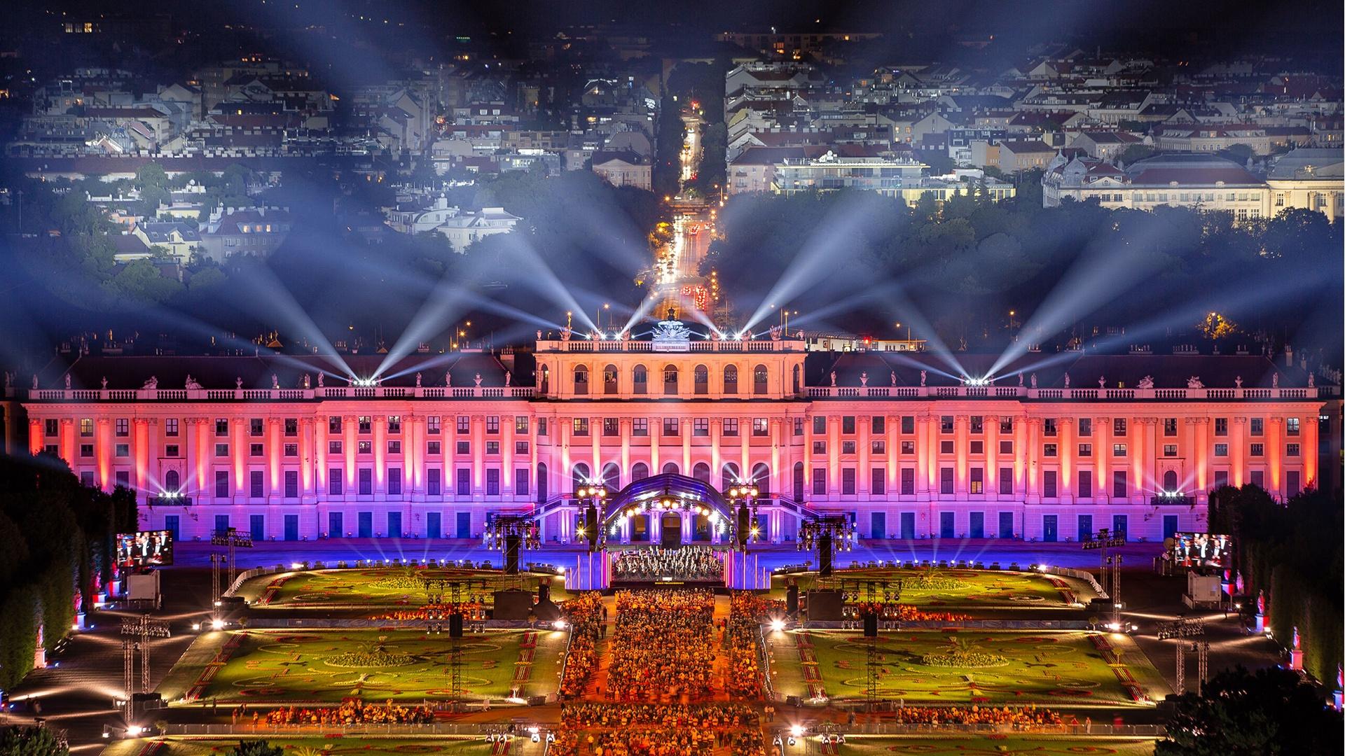 The Vienna Philharmonic performing under colorful stage lighting