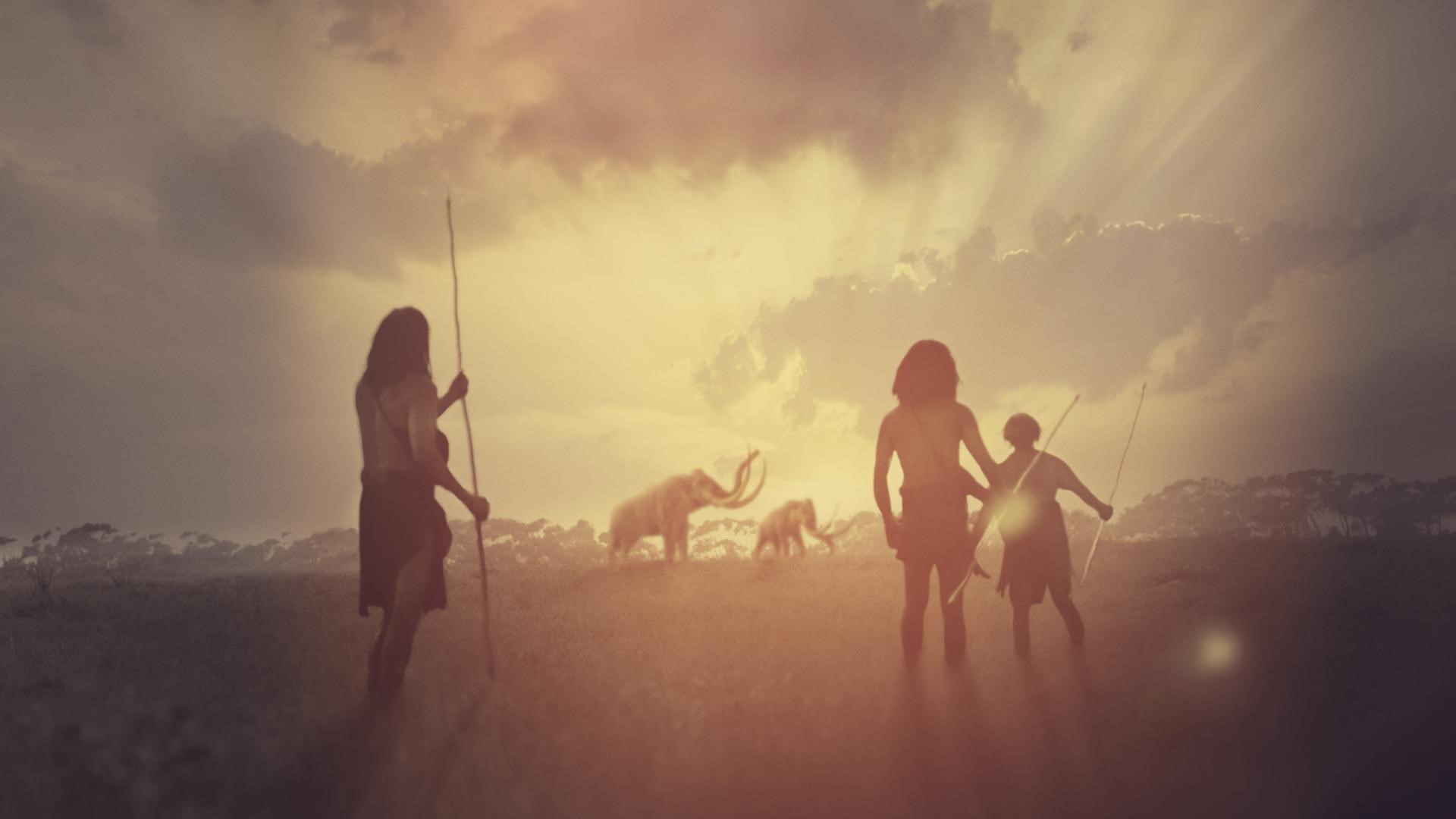 An illustration of ancient humans and wooly mammoths.