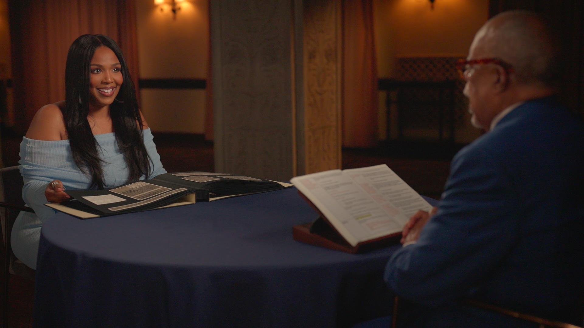 Lizzo sits across the round table from Henry Louis Gates Jr