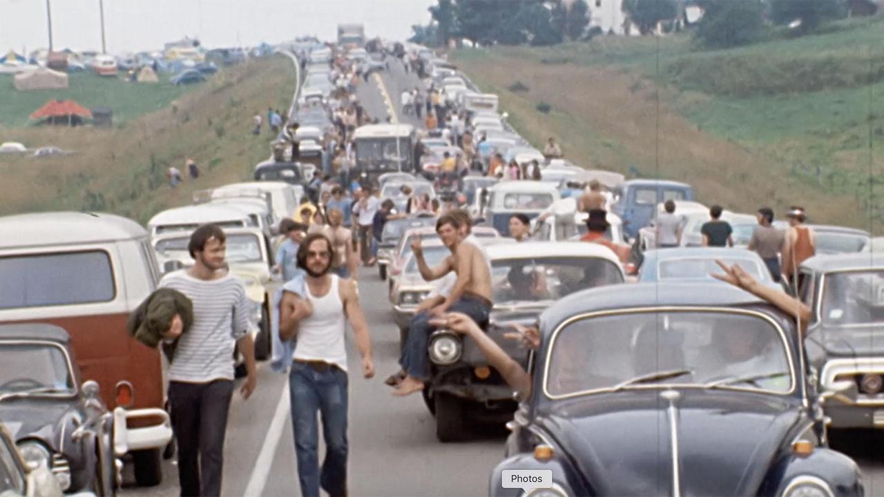Photo of long line of cars and people walking on the way to Woodstock