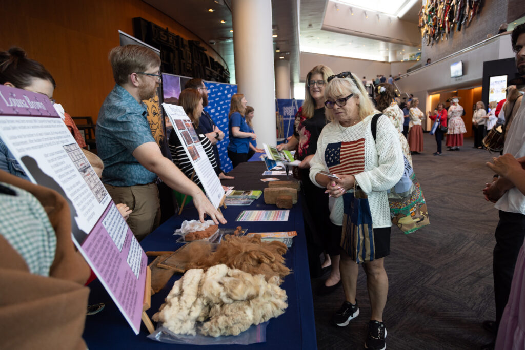 Attendees visiting the Historic Locust Grove booth at KET's Louisville event.