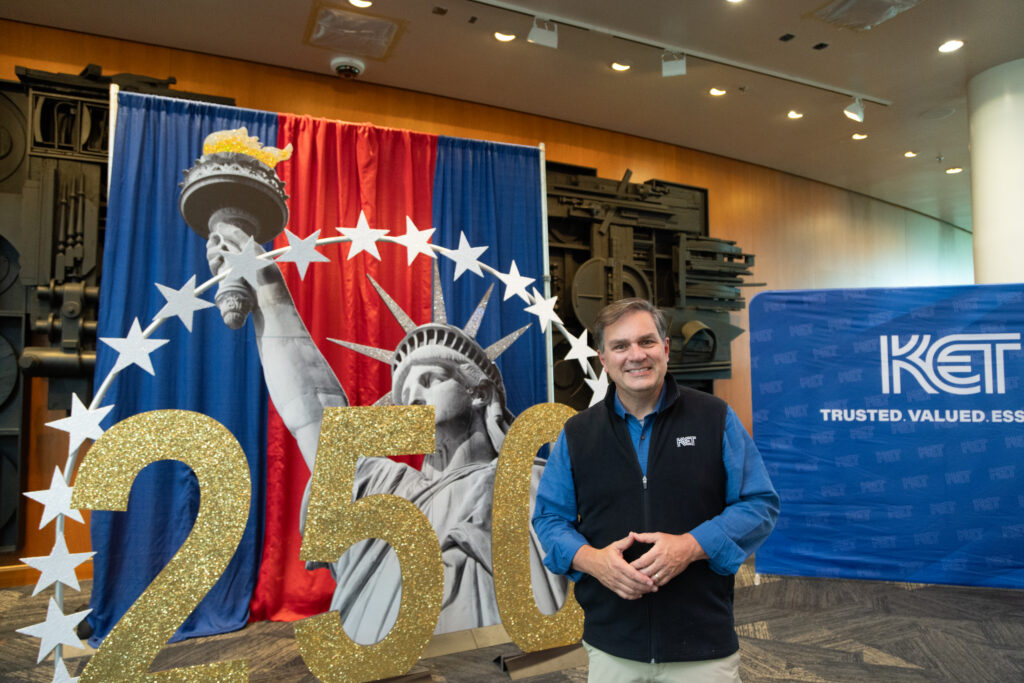 Chip Polston, host of KET's Kentucky Life, posing with themed decor at KET's Louisville event.