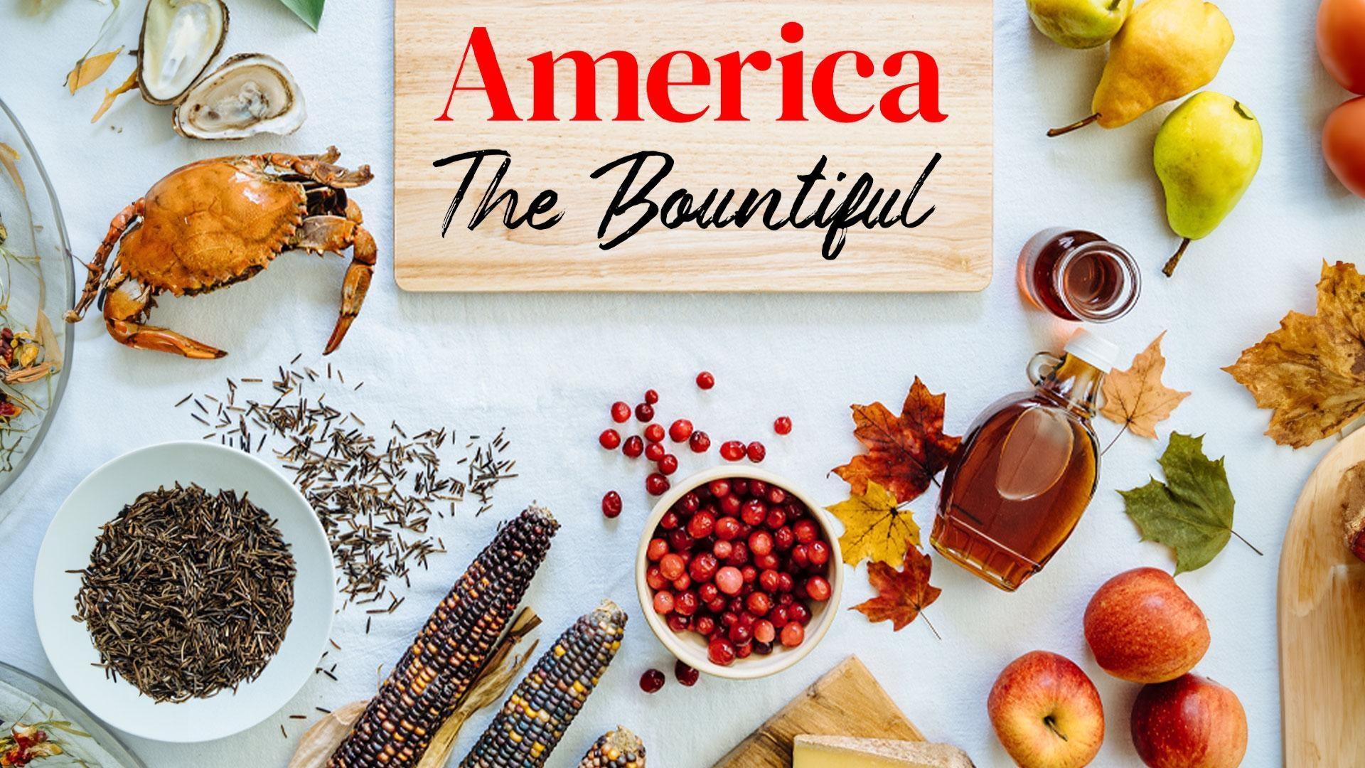 A table with a white tablecloth and lots of foods laid out on it along with the program's title treatment.