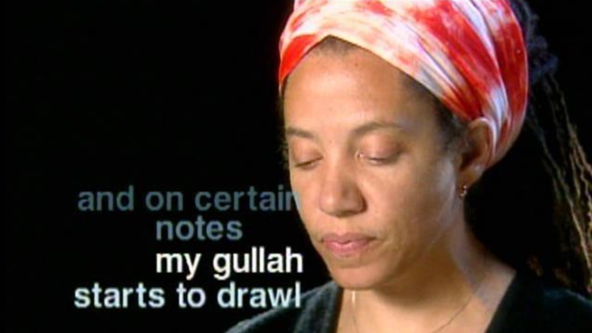 Author Nikky Finney with her hair in a red and white wrap with the words, "and on certain notes my gullah starts to drawl" superimposed over the image.
