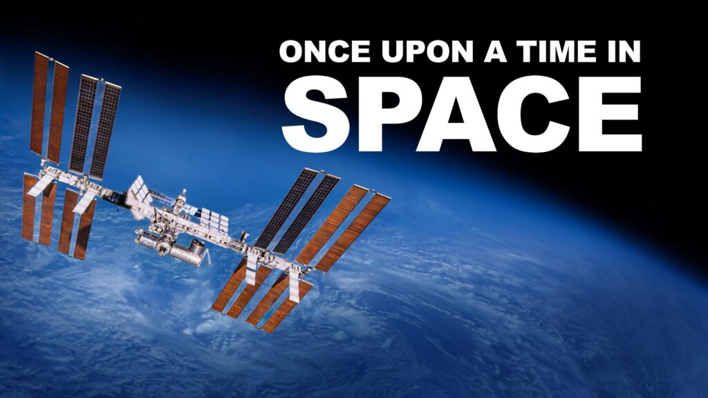 The International Space Station (ISS), a massive orbiting research laboratory composed of multiple modules and solar arrays, floating in space with the Earth behind in. The program title is superimposed over the image.