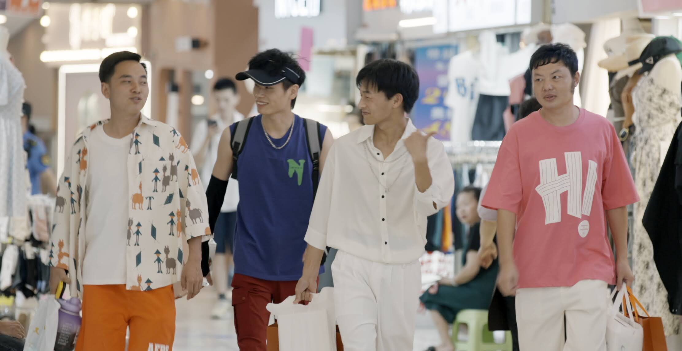 Four young men walking through a department store