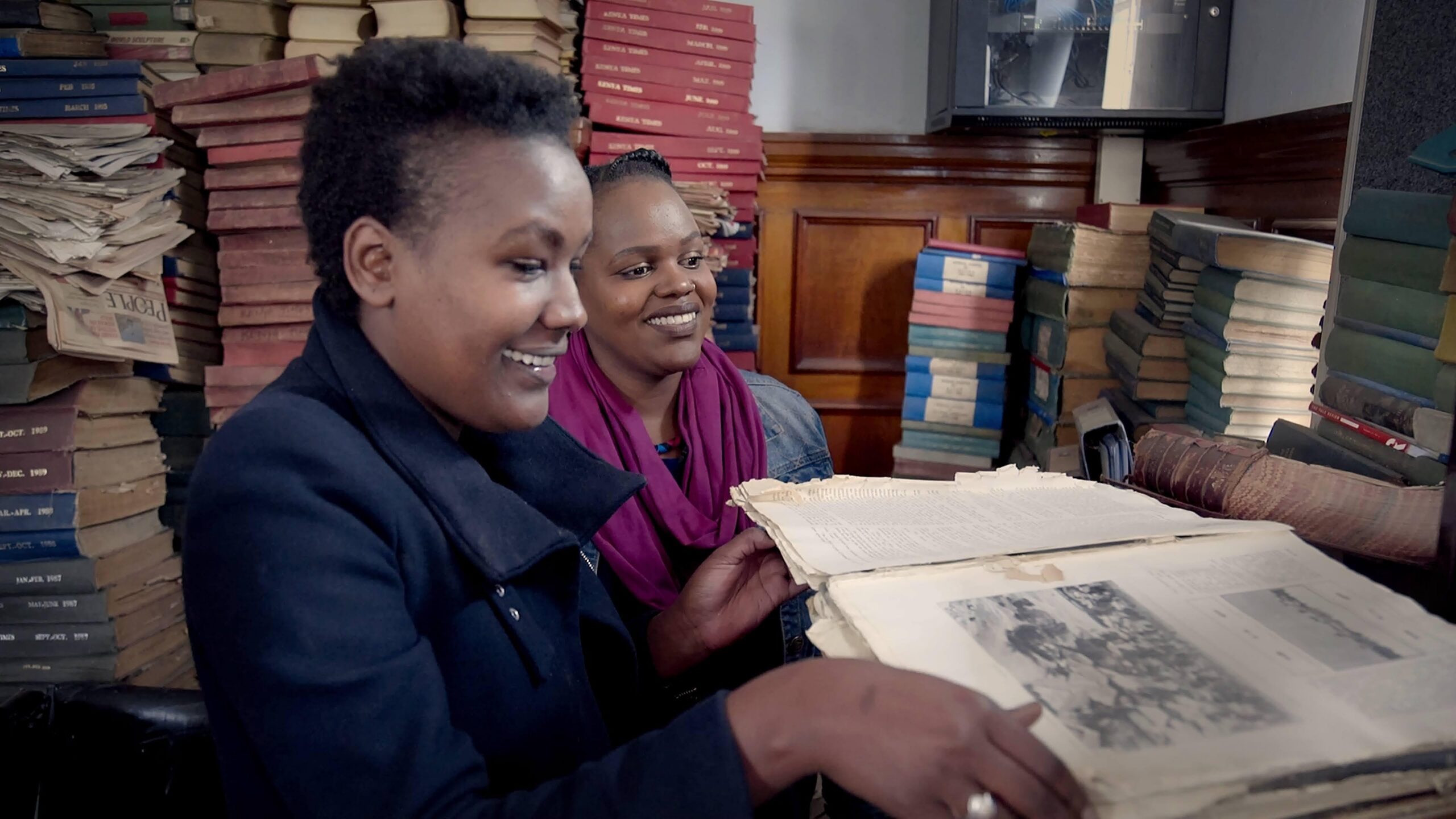 Two Nairobi women surrounded by books and papers