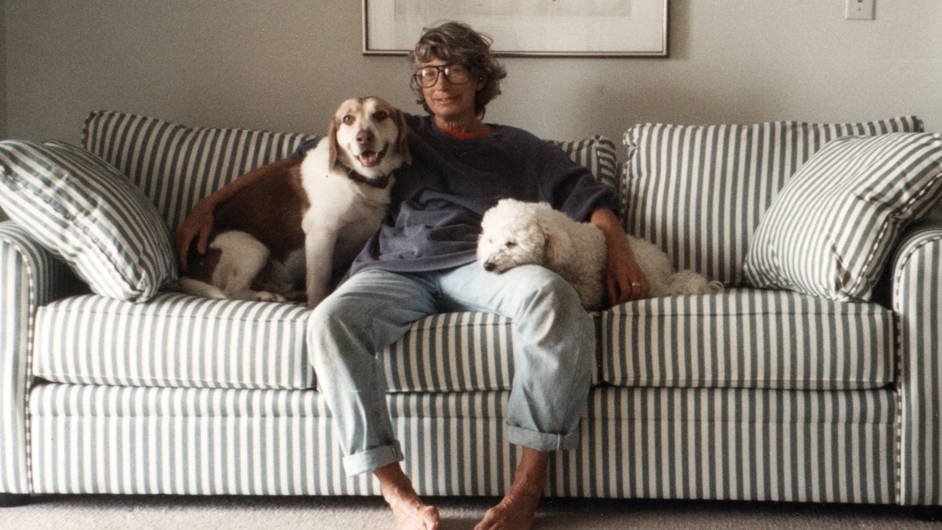 Mary Oliver on a sofa with two dogs in the early 1990s.