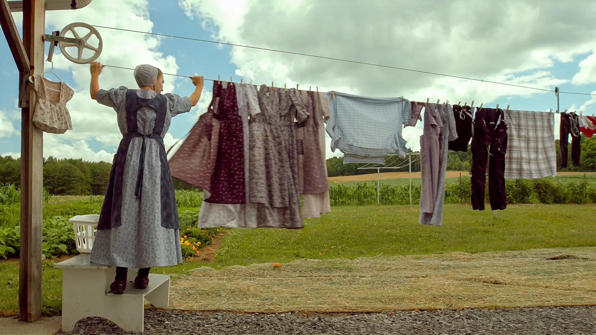 Amish woman hanging clothes on a clothesline