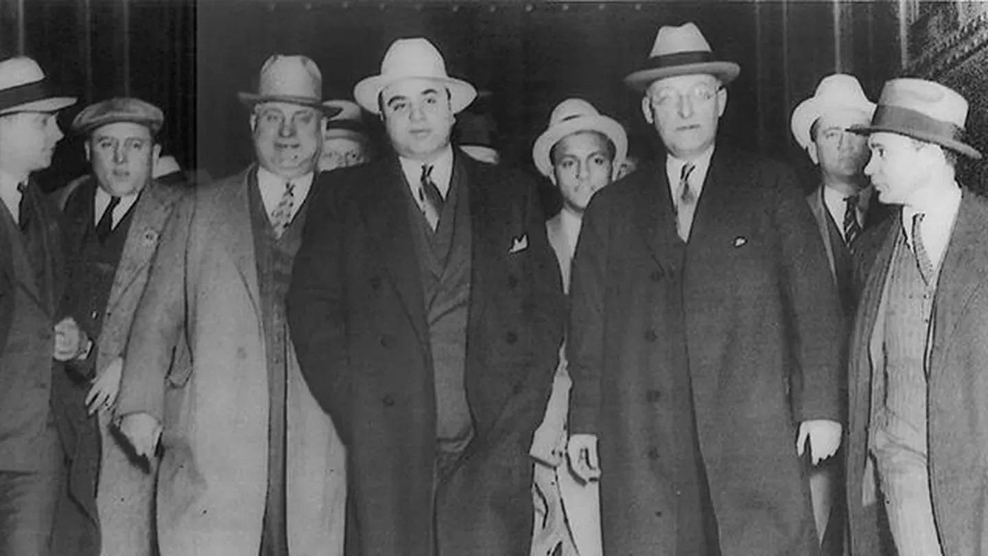 Black and white photo of gangsters standing side by side, Al Capone in the middle