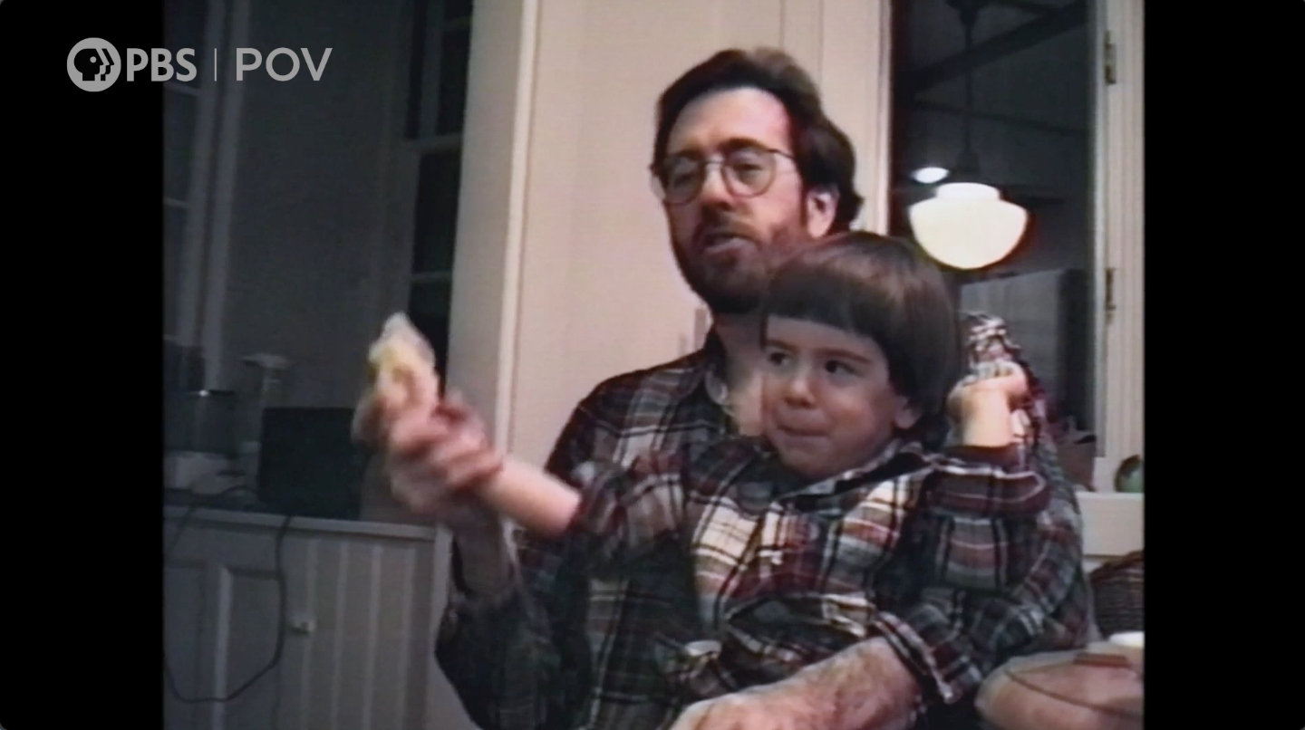 Filmmaker Ross McElwee holding his son when his son was a child