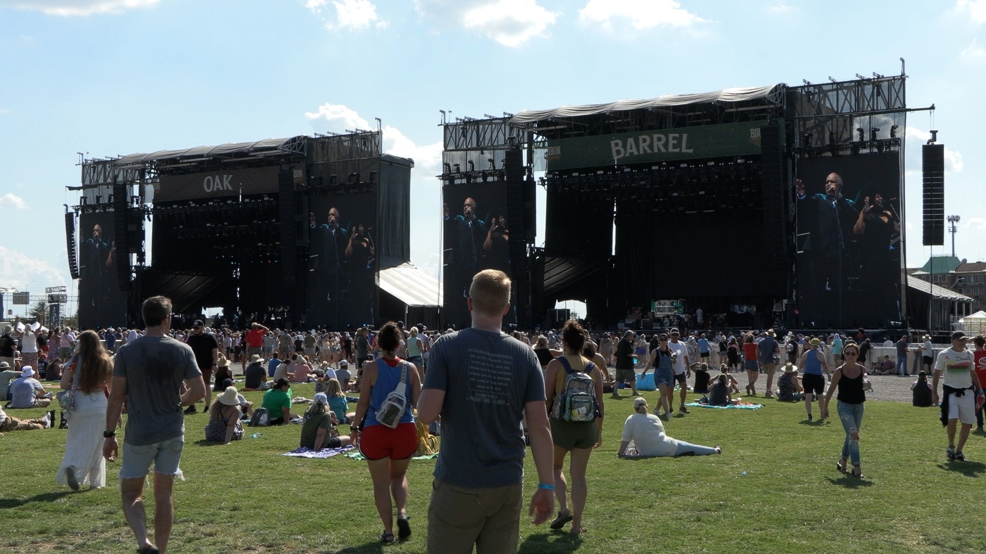 Two of the Bourbon and Beyond stages in an open field with crowds in front
