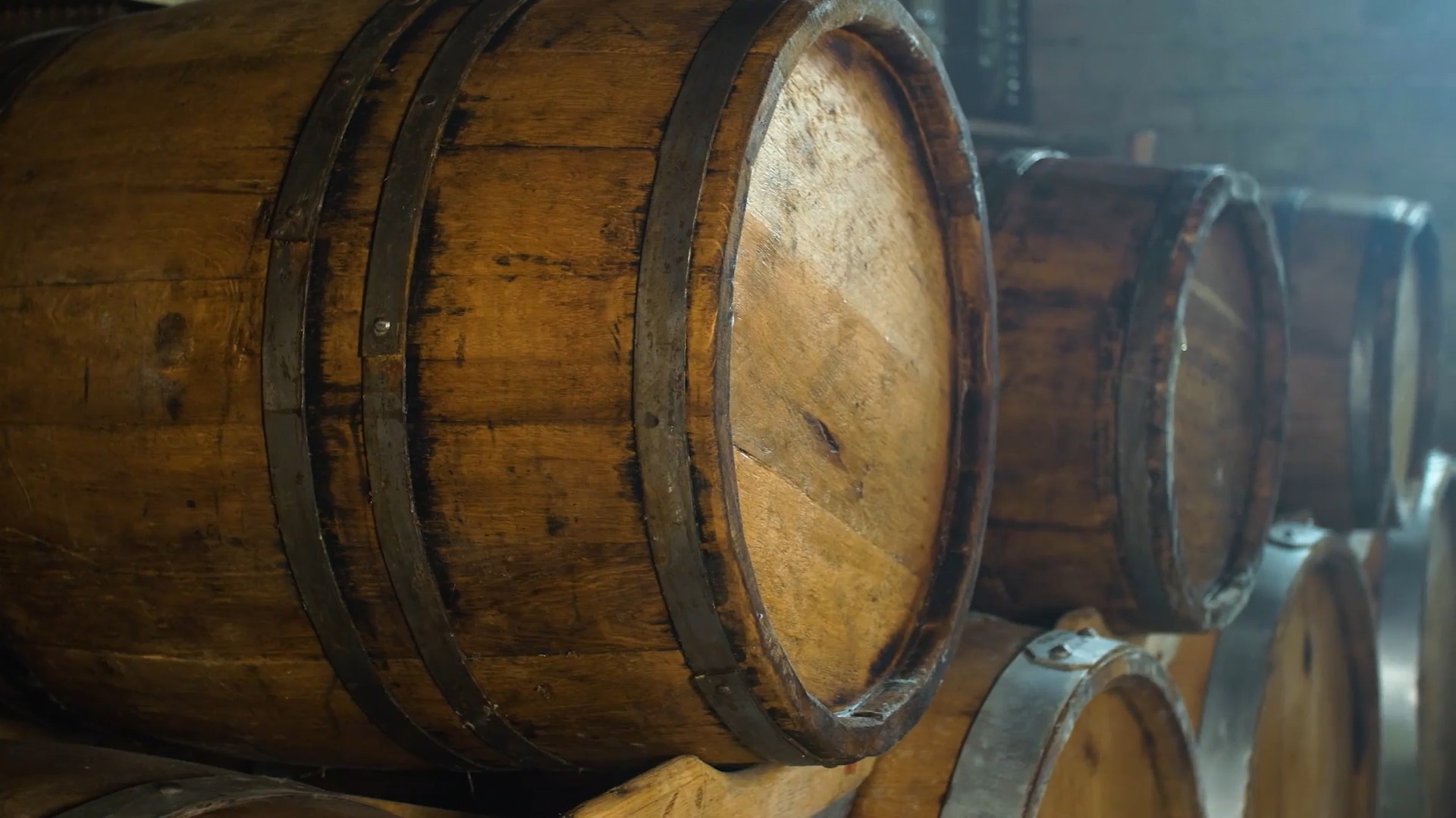 Wooden bourbon barrels in stacks and rows