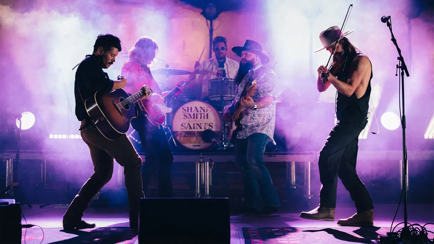 Mostly backlit photo of Shane Smith & The Saints performing at Red Rocks