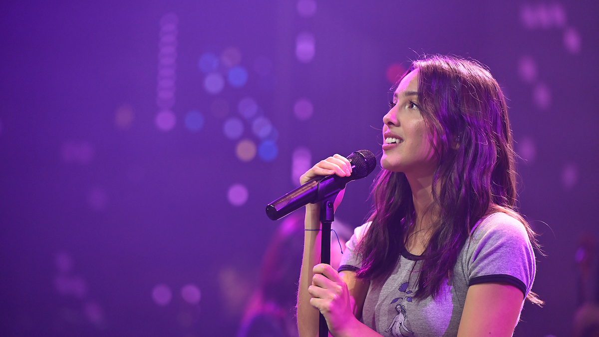 Olivia Rodrigo with a microphone
