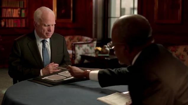 Henry Louis Gates, Jr points to something in John McCain's Book of Life.